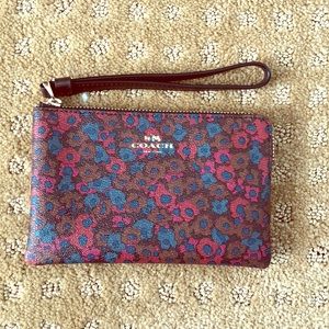 Leather Coach wristlet in floral print